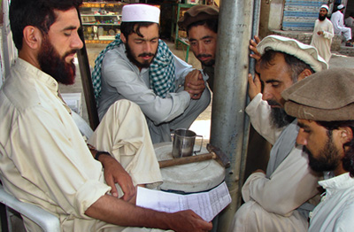 Pakistani tribesmen read a pamphlet distributed by militants at the main bazaar of Miran Shah, the main town of Pakistans tribal region North Waziristan along the Afghan border (AP/Abdullah Noor)