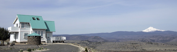 A panoramic view with Mount Jefferson on the horizon is visible from a home in the Three Rivers Recreational Area in Lake Billy Chinook, OR, where everyone lives "off the grid." (AP/Don Ryan)