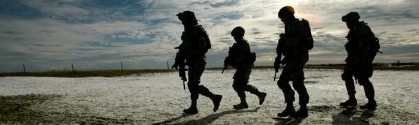 Soldiers running on patrol near Baghdad. (AP)