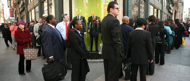 People wait in line to enter a job fair on Wednesday, April 16, 2008 in New York. The number of newly laid off workers filing claims for unemployment benefits increased by 12,000 last week, providing further evidence of strains in the labor market. (AP/Mark Lennihan)