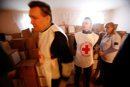Red Cross volunteers distribute food in Chisinau, Moldova where droughts over four of the past five years have severely limited the food supply. (AP/John McConnico)