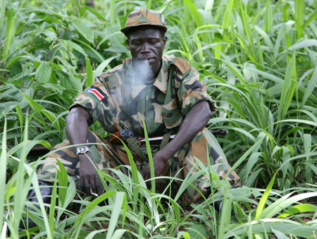 A member of the Sudan’s People Liberation Army awaits the arrival of delegates at Ri-Kwangba in southern Sudan, April 10, 2008. Joseph Kony delayed his expected signing of a peace deal Thursday to end one of Africa's longest wars, saying he needed clarification on terms of the deal. (AP/Glenna Gordon)