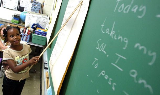 Marshawanda Overstreet , a student at B.C. Charles Elementary School in Newport News, VA, points to the chalkboard during a reading lesson. (AP/Jason Hirschfeld)