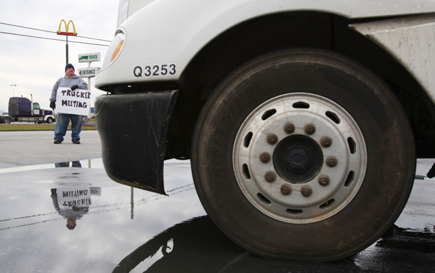 Dave Dellinger of Fredericksburg, Pennsylvania directs truckers to a truck drivers rally to protest high fuel prices at the Gables truck stop in Harrisburg, PA. (AP/Carolyn Kaster)