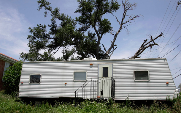 A FEMA trailer sits in front of home in the Lakeview area of New Orleans. U.S. health officials have confirmed that toxic levels of formaldehyde fumes in trailer homes the government provided to Gulf Coast hurricane victims have made as many as 300,000 people sick. (AP/Alex Brandon)