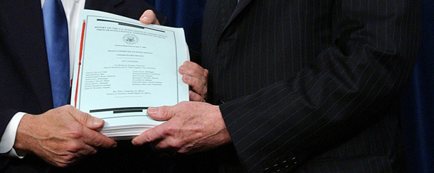 Two members of the Senate Select Intelligence Committee hold up a copy of one of their early reports on pre-Iraq war intelligence. (AP/Dennis Cook)