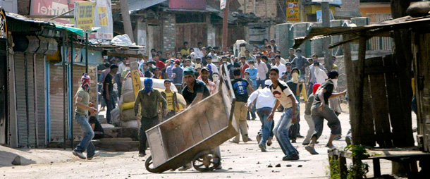 Kashmiri protesters set up a road blockade during a protest earlier this month. Businesses, schools and roads were shut down due to a strike against the government's recent fuel price hike. (AP/Dar Yasin)