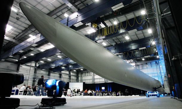 A wind turbine blade is unveiled during the opening of the Vestas blade factory in Windsor, CO in March. The world's largest wind-turbine maker officially opened its first U.S. manufacturing plant on Colorado's northern plains, where it expects to produce blades for 600 turbines a year and create thousands of jobs. (AP/Jack Dempsey)