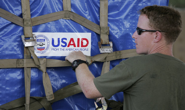 A U.S. marine packages USAID supplies bound for cyclone-devastated Myanmar on May 14, 2008. The United States is the most generous country when it comes to aid, but suffers from short-term reactionary giving. (AP/Wally Santana)