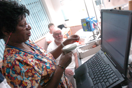 A registered nurse scans a barcode before dispensing medication to a patient in Romney, WV. In her testimony, Lambrew stressed the need for increased health information technology as a way to increase health care efficiency. (AP/Don Wright)