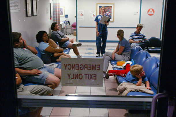 Familiy members and patients wait to be admitted to an emergency room at a hospital in Madera, CA. Conservatives argue that everyone has access to emergency services, but that's no substitute for comprehensive health care. (AP/Gary Kazanjian)