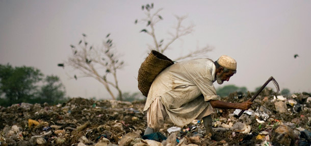 A scavenger searches for recyclable items in a garbage dump outside Islamabad, Pakistan. President Bush pledged $115 million in food aid to the country this week in a meeting with Pakistani Prime Minister Yusaf Raza Gillani. (AP Photo/Emilio Morenatti)