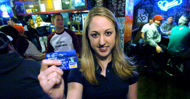 A Washington State University student poses with a credit card at a pub near campus. Campus Progress Action's Erica Williams testified before a House committee that college students are uniquely affected by credit card debt and abusive credit card practices. (AP/Joe Barrentine)