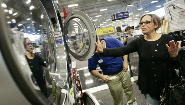 A customer views front-loading washers and dryers at a Best Buy in Burbank, CA. While the second quarter of this year saw a rise in consumer spending, there was a drop in durable goods consumption on items such as washers, dryers, and cars. (AP/Reed Saxon)