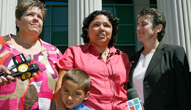 Guadalupe Benitez, center, speaks after hearing the California Supreme Court's ruling in her favor on Monday with her partner Joanne Clark, her son Gabriel Clark-Benitez, and her lawyer, Jennifer Pizer. (AP/Denis Poroy)