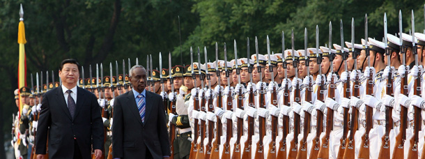 Chinese Vice President Xi Jinping, left, and visiting Sudanese Vice President Ali Osman Mohammed Taha review an honor guard during a welcome ceremony outside the Great Hall of the People in Beijing. (AP/Color China Photo)