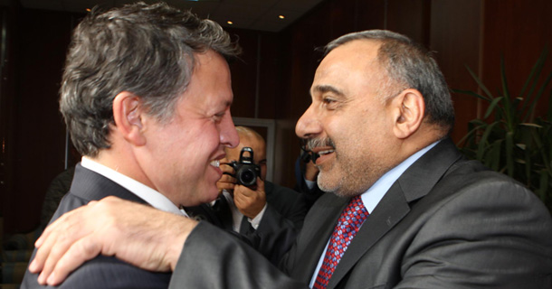 Iraqi Vice President Adel Abdul-Mahdi, right, welcomes Jordan's King Abdullah, left, in Baghdad, Iraq on Monday. (AP/Jordan Royal Palace)