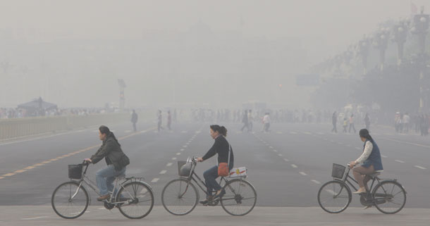 Chinese girls bike through Tianamen Square in Beijing. Pollution in the city will be an issue during the upcoming Olympics, despite Chinese efforts to improve air quality in the weeks leading up to the games. (AP Photo/Oded Balilty)