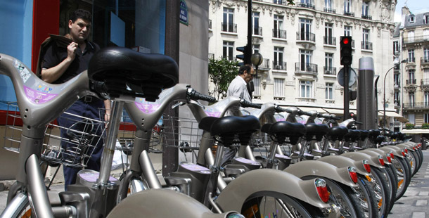 Men examine bicycles in Paris. The city's bike-sharing program, "Velib," has more than 1,450 stations and 20,000 bikes in use. (AP/Michel Spingler)