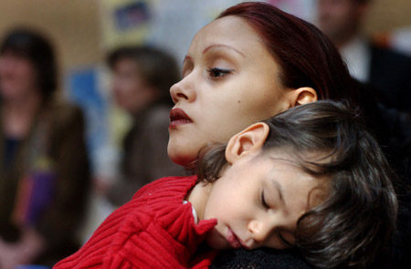 Adria Roman, 18, of Boston, and her son, Diano Perez, 3, attend a rally to support programs to help educate young mothers about teen pregnancy prevention. Violence in girls' lives is often overlooked in prevention efforts. (AP/Patricia McDonnell)