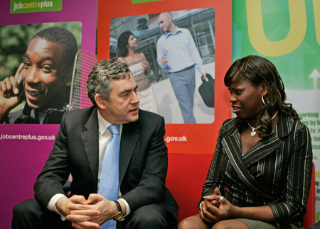 British Prime Minister Gordon Brown talks to Dolapo Oduwole earlier this year on the 10th anniversary of his Labour Party's New Deal employment program. Oduwole is a single mother who found work through a job center in central London. (AP/Lefteris Pitarakis)