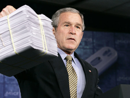 President George W. Bush holds up a pile of earmarks as he speaks about the economy in Manassas, VA, on February 6, 2007. Congressional earmarks get a lot of press, but the president is earmarker-in-chief. (AP/Charles Dharapak)