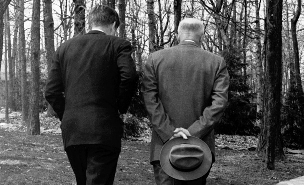 President John F. Kennedy, left, and former President Dwight D. Eisenhower with their heads bowed as they walk along a path at Camp David in Thurmond, Md. in April 22, 1961, as the two met to discuss the Bay of Pigs invasion. (AP/Paul Vathis)