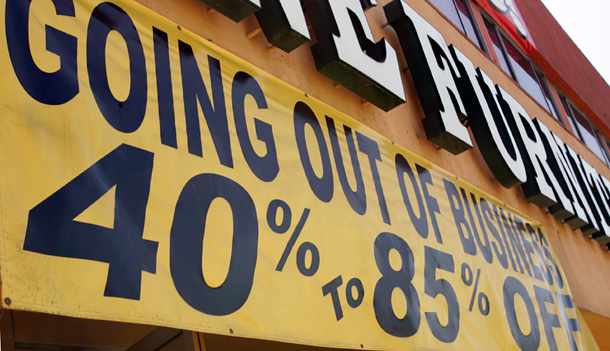Going-out-of-business signs are seen at Expo Furniture in Torrance, CA. Wholesale inflation has surged in recent months, leaving U.S. prices for the past year rising at the fastest pace in 27 years. (AP/Reed Saxon)