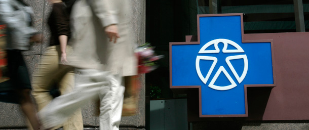 Pedestrians walk in front of the Independence Blue Cross headquarters in Philadelphia last year, while Pennsylvania's two largest health insurers met inside to decide whether or not to merge. (AP/Matt Rourke)