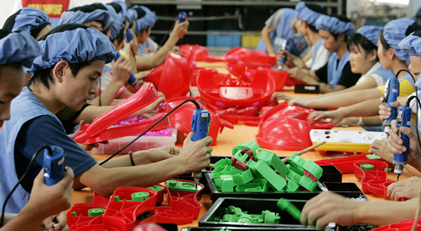 Workers assemble toys in a factory in China. Good labor standards can benefit both workers in developing countries and U.S. trade. (AP Photo/Eugene Hoshiko)