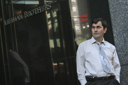 A man stands outside the Lehman Brothers headquarters on September 15, 2008. The collapse of Lehman Brothers is another symptom of deeper issues affecting the economy. (AP/Mary Altaffer)