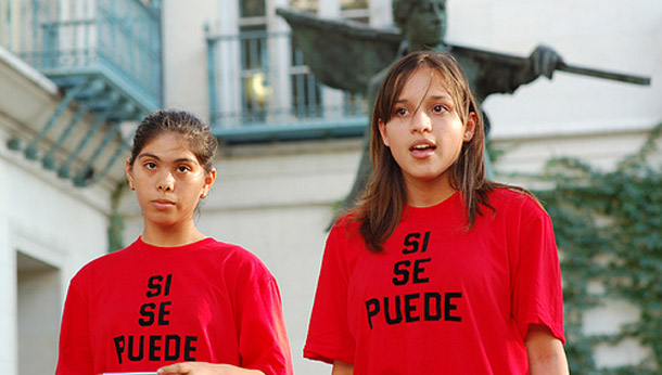 Two girls wear "Si se puede" T-shirts at the Cesar Chavez Statue Dedication at the University of Texas-Austin on October 9, 2007. The phrase was the rallying cry for Chavez's United Farm Worker's Union in the 1970s. (flickr/roxannejomitchell)