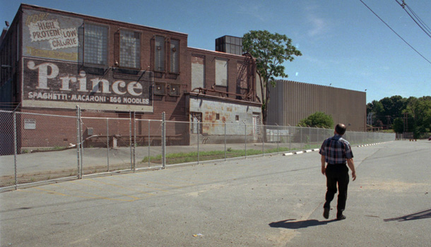 Francisco Brum, who worked at the Prince pasta plant for 25 years, walks past the factory for perhaps the last time after it closed, putting 300 employees out of work. (AP/Gail Oskin)