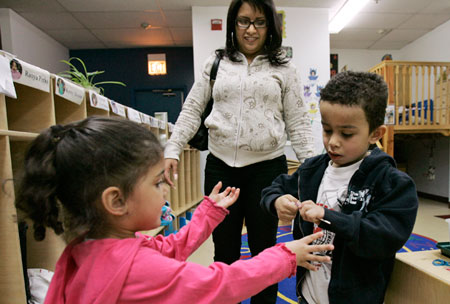 Michelle Ramirez picks her children up from day care; the single mother of two is struggling to make ends meet on her receptionists salary as day care and medical costs rise. (AP/Charles Rex Arbogast)