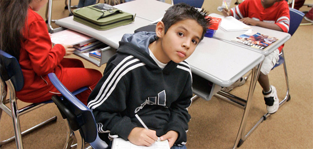 Middle schooler Jesse Jasso copies a word off the board during an English language learners class. (AP/Nati Harnik)