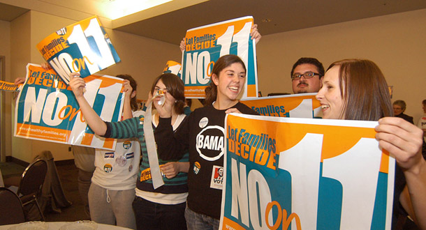 Members of the group leading the opposition to the proposed law to ban abortion in South Dakota cheer during a T.V. interview Tuesday, Nov. 4, 2008. (AP/Doug Dreyer)