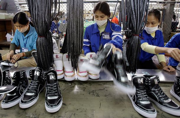 Workers work on assembly line of shoes at Thuong Dinh Shoe factory in Hanoi, Vietnam, which produces shoes for domestic markets and for exports. (AP/Chitose Suzuki)
