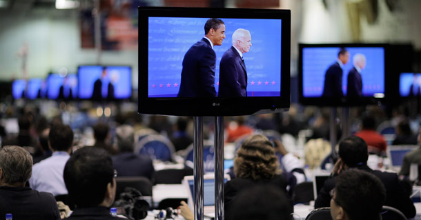 Sens. Barack Obama and John McCain are shown on television screens at the media filing center during the final presidential debate held at Hofstra University. (AP/Jae C. hong)