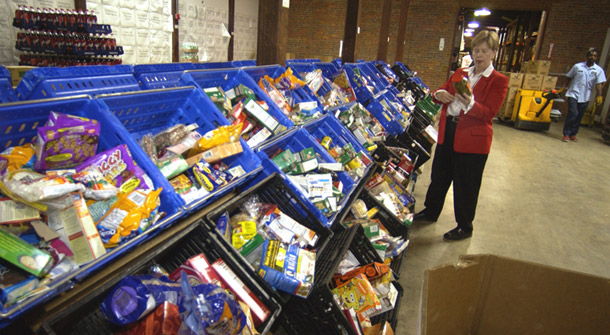 Central Virginia Food Bank CEO Fay Lohr examines bins of food at a Food Bank in Richmond. A new report from the USDA shows that hunger significantly increased in 2007. (AP/Steve Helber)