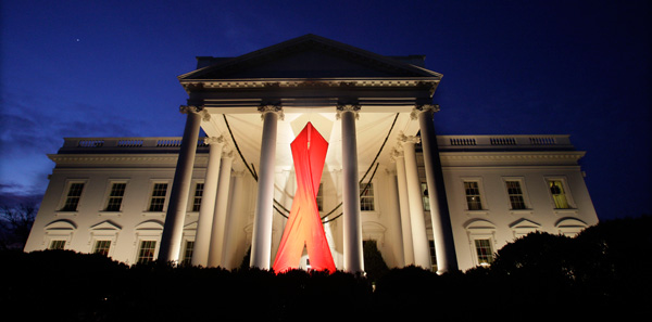 A large AIDS ribbon hangs from the North Portico of the White House in honor of World AIDS Day last year. (AP/Ron Edmonds)