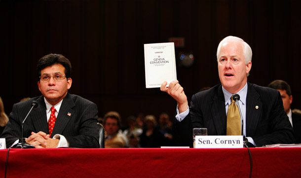 At Alberto Gonzales' confirmation hearing for attorney general in 2005, Sen. John Cornyn (R-TX) holds up a copy of the Geneva Conventions while saying that it does not apply to terrorists. Policies Gonzales supported were believed to have led to the torture of terrorism detainees. (AP/Susan Walsh)