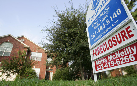 A foreclosed sign on a lawn in Spring, TX. Bolder action akin to an economic quarantine is needed to stem the housing crisis and its repercussions. (AP Photo/David J. Phillip)