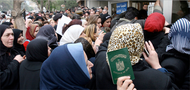 Thousands of Iraqi refugees gather outside the offices of a U.N. refugee agency in Syria's capital city Damascus to register their names for obtaining a refugee status. (AP/Bassem Tellawi)