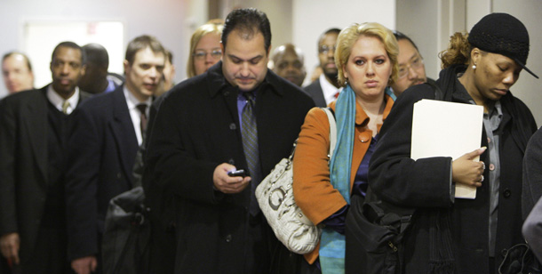 Job seekers line up to attend a job fair in Chicago on January 27, 2009. The Bureau of Economic Analysis reported this morning that the economy shrank by an estimated annual rate of 3.8 percent in the fourth quarter of 2008, the largest drop since the first quarter of 1982. (AP/M. Spencer Green)