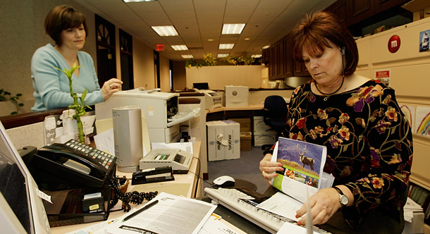 Two women—a paralegal and a lawyer—at work in their office. More than 45 years after the passage of the Equal Pay Act, women still make 78 cents on the dollar compared to men. (AP/Damian Dovarganes)