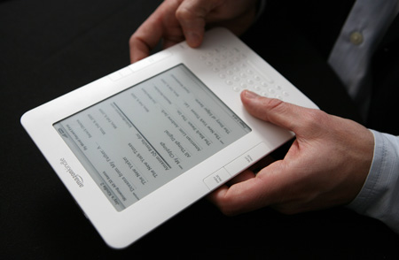 The Amazon Kindle 2 e-reader is shown at an Amazon.com news conference on February 9, 2009. Some evidence suggests e-readers are better than both print and online reading when it comes to environmental impact. (AP/Mark Lennihan)
