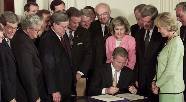 President Bush signs his $1.35 trillion tax cut on June 7, 2001, at the White House. (AP/Ron Edmonds)