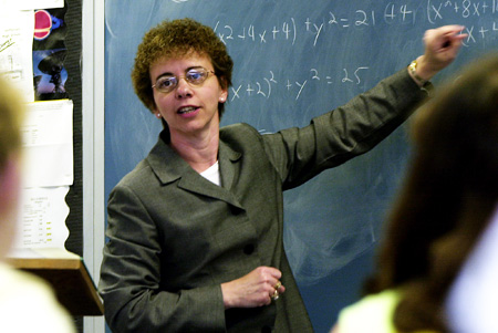 Math teacher Betty Davis goes over an algebra problem with students at Jefferson High School in Shenandoah Junction, West Virginia. The Senate compromise legislation cuts aid to programs that disproportionately employ women. (AP/Jason Turner)