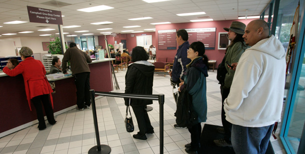 People wait in line at an Employment Development Department office in San Jose, CA last month. The final version of the Recovery Act isn’t as good as it might have been, but it will still create or save 3 million to 3.5 million jobs over the next two years. (AP/Marcio Jose Sanchez)