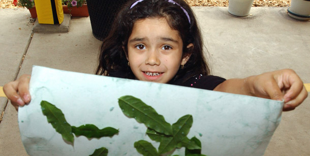 A preschooler holds up her finished art work at a Head Start Program in Hillsboro, Oregon. Head Start is one of the programs that would be expanded under the House stimulus plan.
<br /> (AP/Greg Wahl-Stephens)